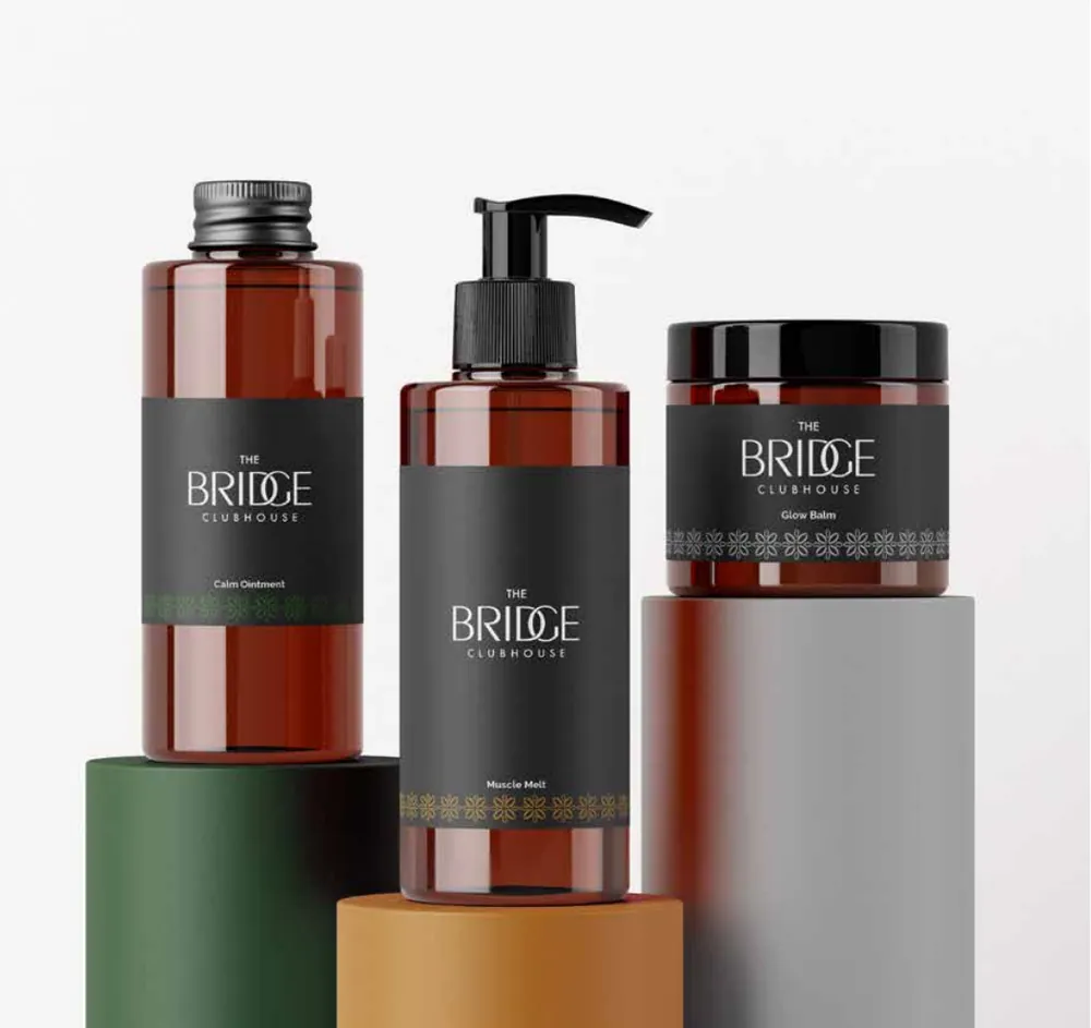 Bath & body bottles, branded with The Bridge Clubhouse identity
