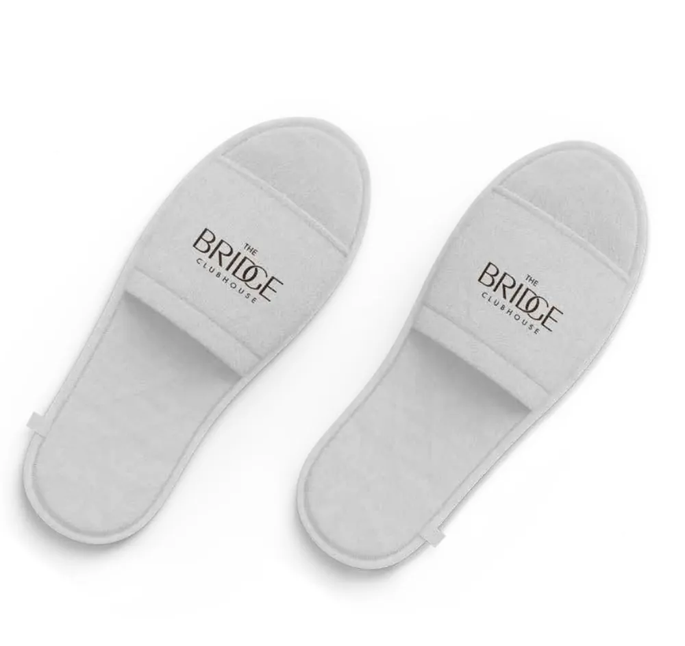 Guest slippers, branded with The Bridge Clubhouse identity